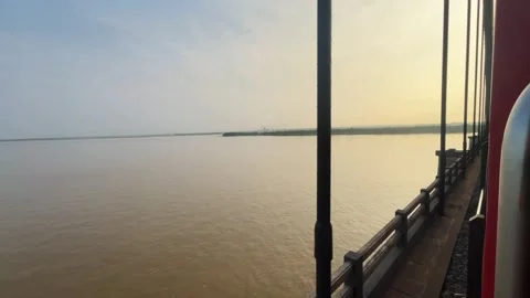 Indian Train Crossing Arch Bridge Over Wide Godavari River at Sunrise. Stock Footage 346472507