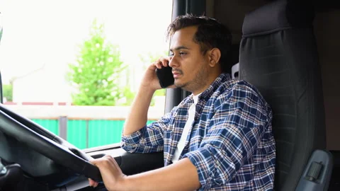 Indian trucker phoning while sitting in his truck Stock Footage 251833433