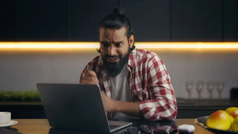 Indian web developer reading good news email on laptop, celebrating success Stock Footage 313281299