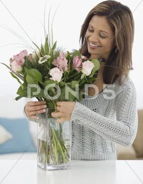 Indian woman arranging flowers Stock Photos