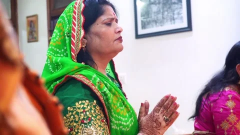 Indian Woman Clapping Hands In Devotion To God During Diwali Pooja Aarti Stock-Footage 146943867