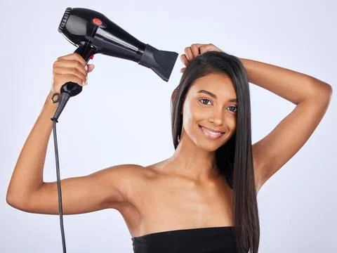 Indian woman, hair care or dryer in studio portrait for healthy natural shine Stock Photos