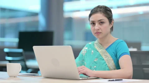 Indian Woman Looking at Camera while using Laptop Video stock 152521304