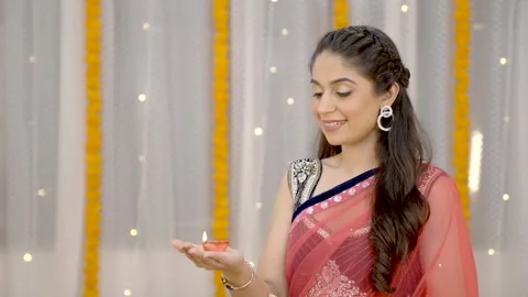 Indian woman looking towards buring lamp Stock Footage 249398658