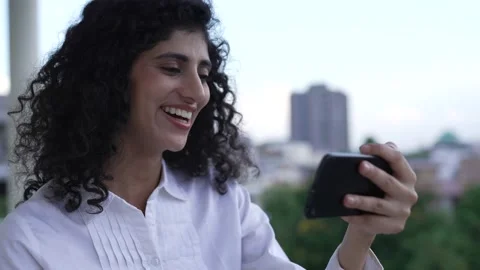 Indian woman standing while using smart phone watching funny videos. Видео 170428954