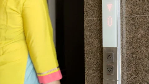 Indian woman walks inside empty elevator - apartment complex, lift control pa... Stock Footage 259802457