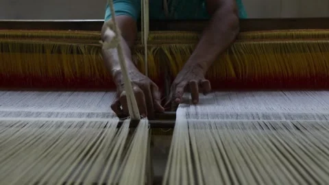 Indian woman working on a handloom Stock Footage