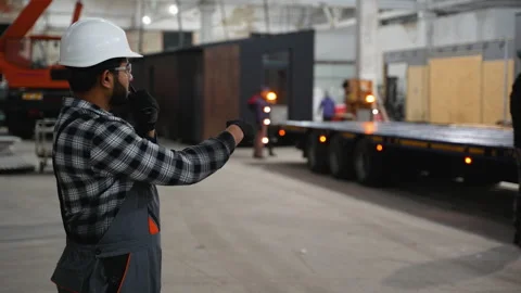 Indian worker directing modular home loading onto trailer Stock Footage 301822098