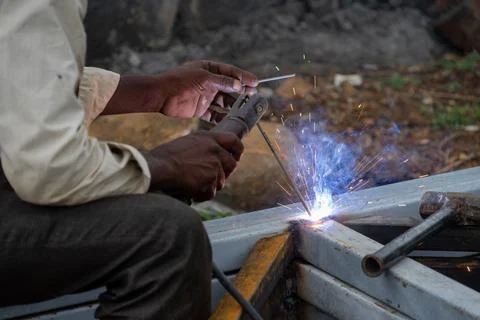 Indian worker doing welding. Close-up Metal worker welding iron in a workshop Fotos de archivo