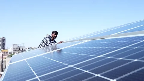 Indian worker installing solar panels on roof of house. Stock Footage 270753008