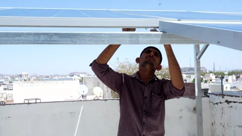 Indian worker installing solar panels on roof of house. Maintenance of phot.. Stock Footage 270753041