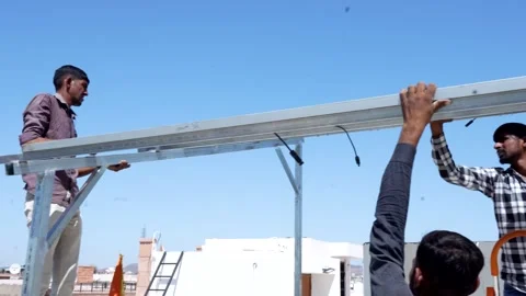 Indian worker installing solar panels on roof of house. Maintenance of phot.. Stock Footage 270753829