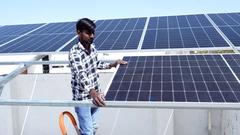 Indian worker installing solar panels on roof of house. Maintenance of phot.. Stock Footage 270754340