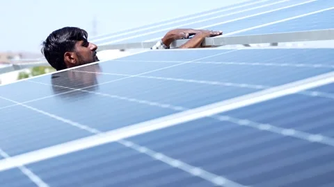 Indian worker installing solar panels on roof of house. Maintenance of phot.. Stock Footage 270754652