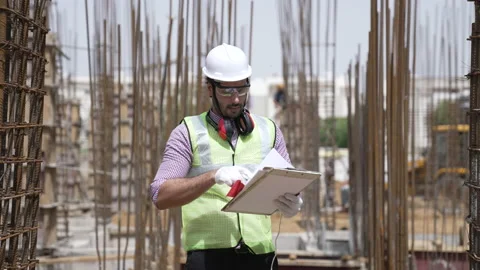 Indian worker man using site plans for project planning. Видео 162014933