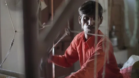 An Indian worker operating a manual loom in a textile factory. Rajasthan, India. Stock Footage 151902096