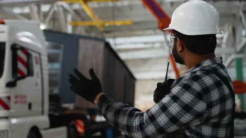 Indian worker supervises the loading of a modular home onto a truck Stock Footage 301822995