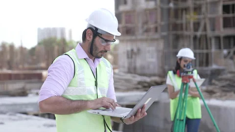 Indian worker using devices to checking plan details on construction site. Видео 161809851