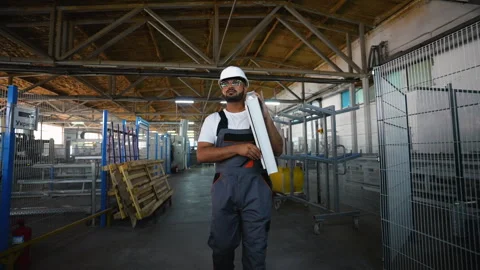 Indian worker walks with a window frame in a window factory Stock Footage 283006874