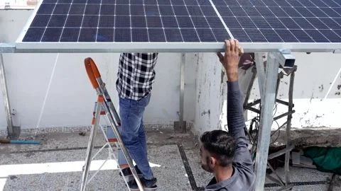 Indian workers installing solar panels on roof of house. Maintenance of pho.. Stock Footage 270753973