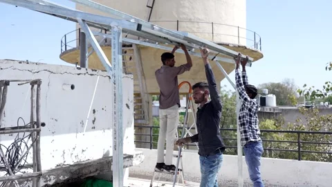 Indian workers installing solar panels on roof of house. Maintenance of pho.. Stock Footage 270754339