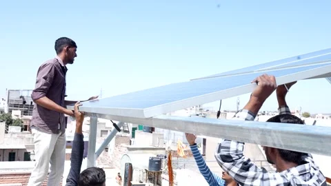 Indian workers installing solar panels on roof of house. Maintenance of pho.. Stock Footage 270754646