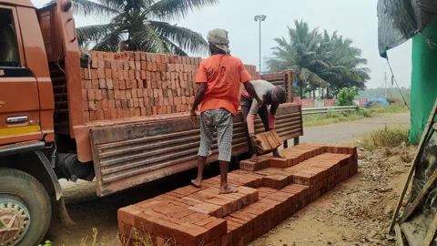 Indian workers unloading red bricks from... | Stock Video | Pond5