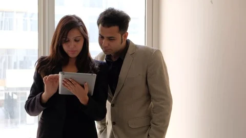 Indian working colleagues wave their hands to greet someone in the morning while Stock Footage 100629358