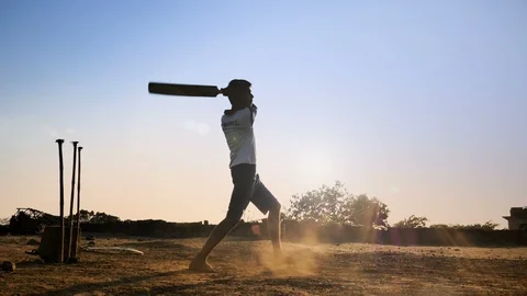An Indian young boy hits the cricket ball for a six India Stock Footage