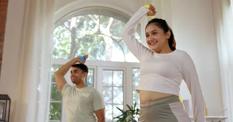 Indian young couple doing strength training with resistance bands Stockbeeldmateriaal 343407590