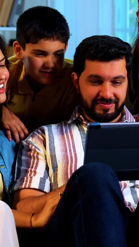 Indian young family using tablet computer at home browsing content together 스톡 동영상 342804027