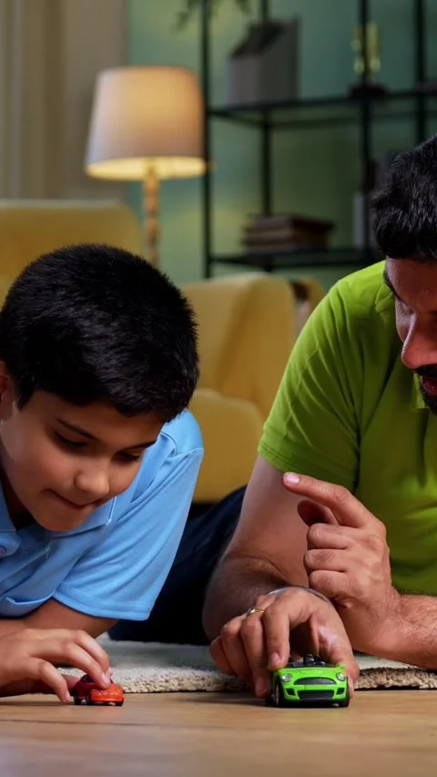 Indian young father son playing toy car race enjoying playful bonding time 스톡 동영상 342758137