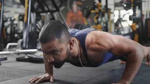 Indian young healthy man performs body weight push ups in a modern gym Stock Footage 341855931