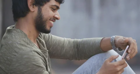 Indian young man having fun with smartphone Stock Footage 157167157