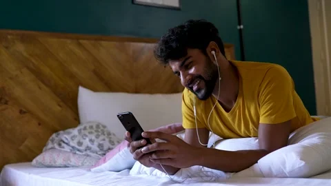 Indian young man making video call by smart phone, at home. Video stock 154732148