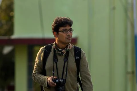 An Indian young man walking through the snow Stock Photos