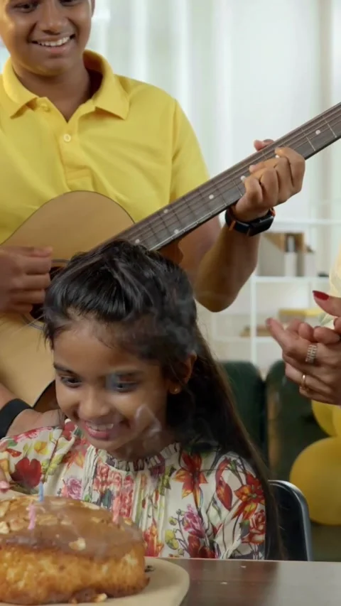 Indian young parents and two small kids celebrating birthday with cake Stock Footage 343364912