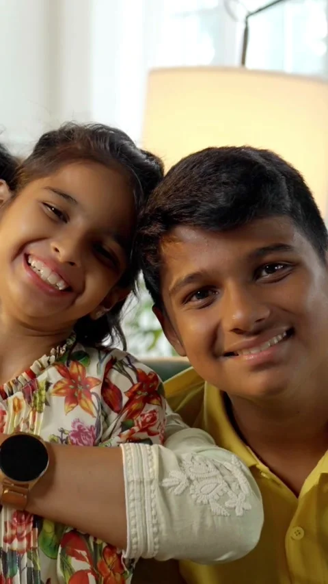 Indian young parents and two small kids spending quality time together indoors Stock Footage 343364989
