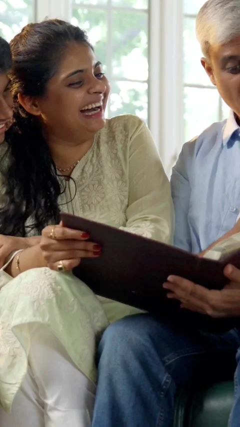 Indian young parents and two small kids spending quality time together indoors Stock Footage 343365036