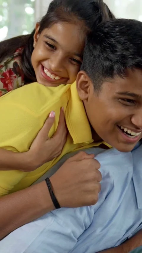 Indian young parents and two small kids spending quality time together indoors Video stock 343365059