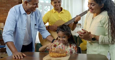 Indian young parents and two small kids celebrating birthday with cake 스톡 동영상 343367752