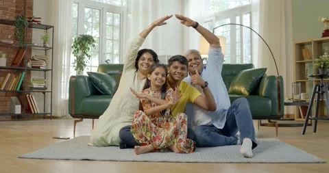 Indian young parents and two small kids spending quality time together indoors Video stock 343369342