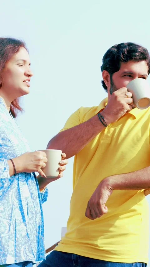 Indian young smart couple spending quality time standing at balcony chatting Stock-Footage 343415629