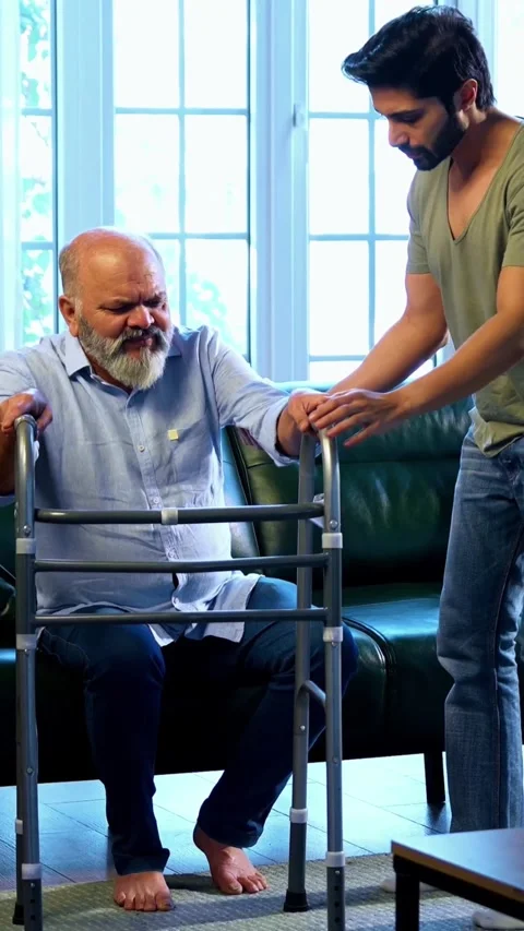 Indian young Son Helping aged Father Stand And Walk With Walker Support At Home Stockbeeldmateriaal 342757632