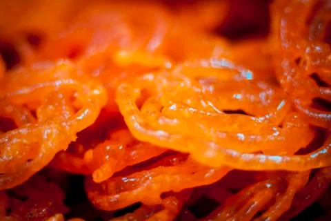 A Indian/Asian circular liquid and solid sweet dish Jalebi of light orange co 스톡 사진