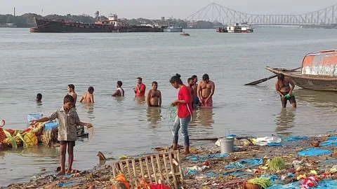 Indians are taking bath in the polluted river the Ganges Stock-Footage 179065551