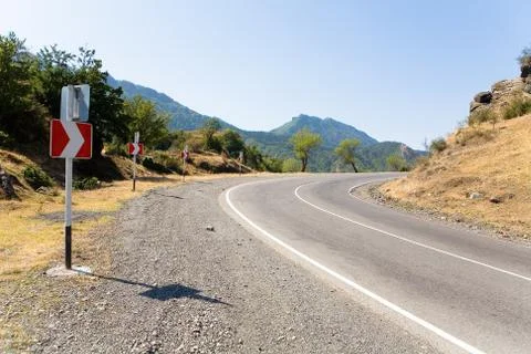 Indicators of a dangerous turn on the road. Stock Photos