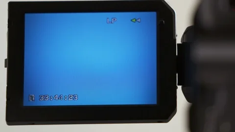 Indicators on LCD screen of digital camcorder while rewinding mini DV cassette Stock Footage 102085255