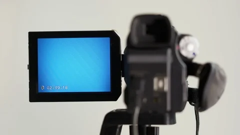 Indicators on the LCD screen of digital Mini DV tape camcorder mounted on tripod Stock Footage 99484738
