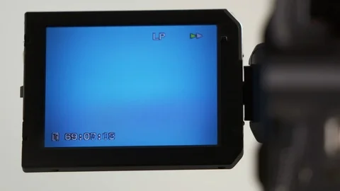 Indicators on screen of digital camcorder while rewinding mini DV cassette tape Stock Footage 99484783